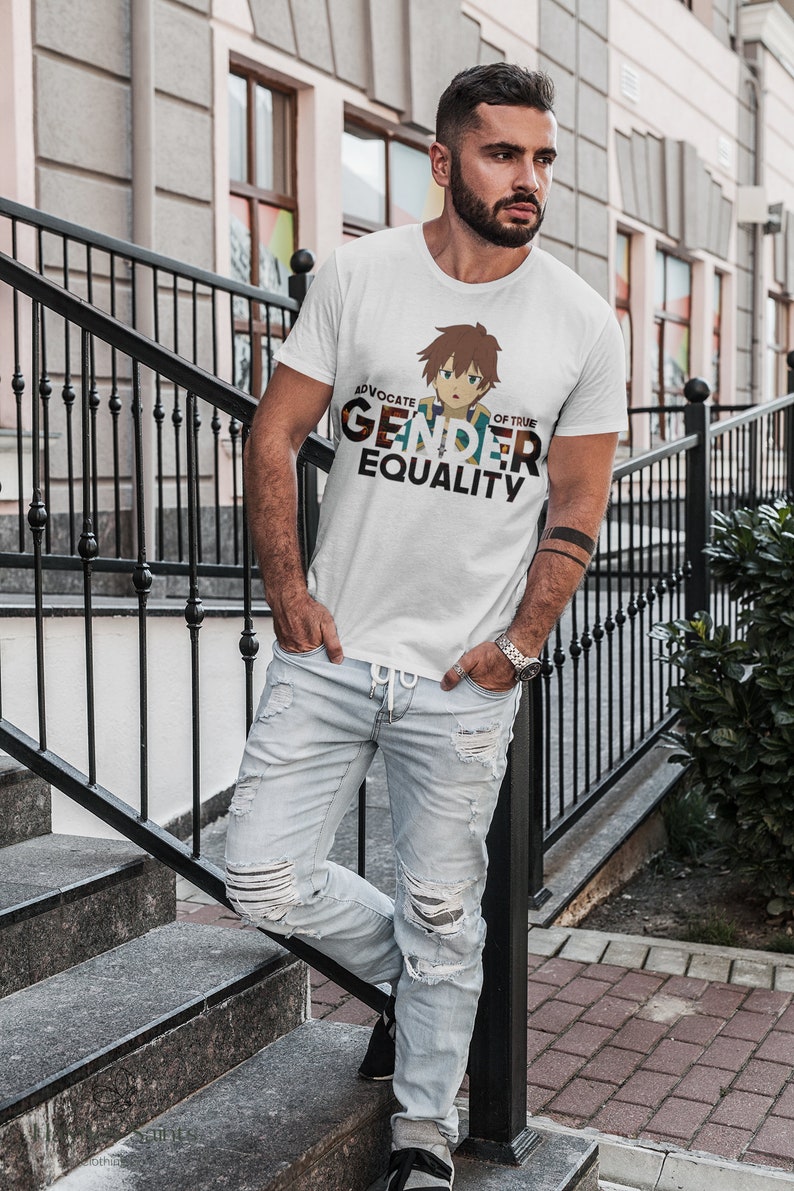May include: A white t-shirt featuring a cartoon character and the text "Advocate of True Gender Equality". The person wearing the shirt is standing on a set of stairs.