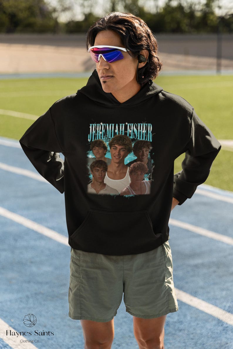 May include: Black hooded sweatshirt featuring the text "JEREMIAH FISHER" above a collage of images. The sweatshirt is worn by a person wearing sunglasses. The brand logo "Haynes Saints Clothing Co." is visible at the bottom.