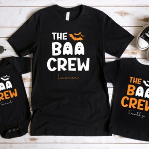 May include: Three black t-shirts with the text "The Boo Crew" and a ghost graphic. The shirts are personalized with the names "Lauren", "Samuel", and "Timothy".
