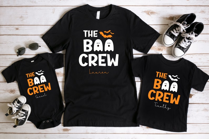 May include: Three black t-shirts with the text "The Boo Crew" and a ghost graphic. The shirts are personalized with the names "Lauren", "Samuel", and "Timothy".