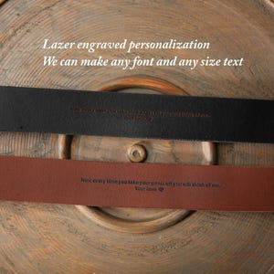 May include: Two leather belts, one black and one brown, with engraved text. The black belt has the text "Now every time you take your pants off you will think of me. Your love". The brown belt has the text "Now every time you take your pants off you will think of me. Your love".