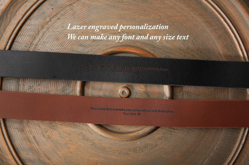 May include: Two leather belts, one black and one brown, with engraved text. The black belt has the text "Now every time you take your pants off you will think of me. Your love". The brown belt has the text "Now every time you take your pants off you will think of me. Your love".
