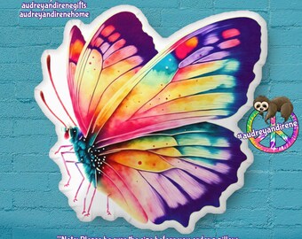May include: A colorful butterfly pillow with a watercolor design. The butterfly has wings with shades of purple, pink, yellow, orange, and blue. The pillow is a great addition to any home decor.