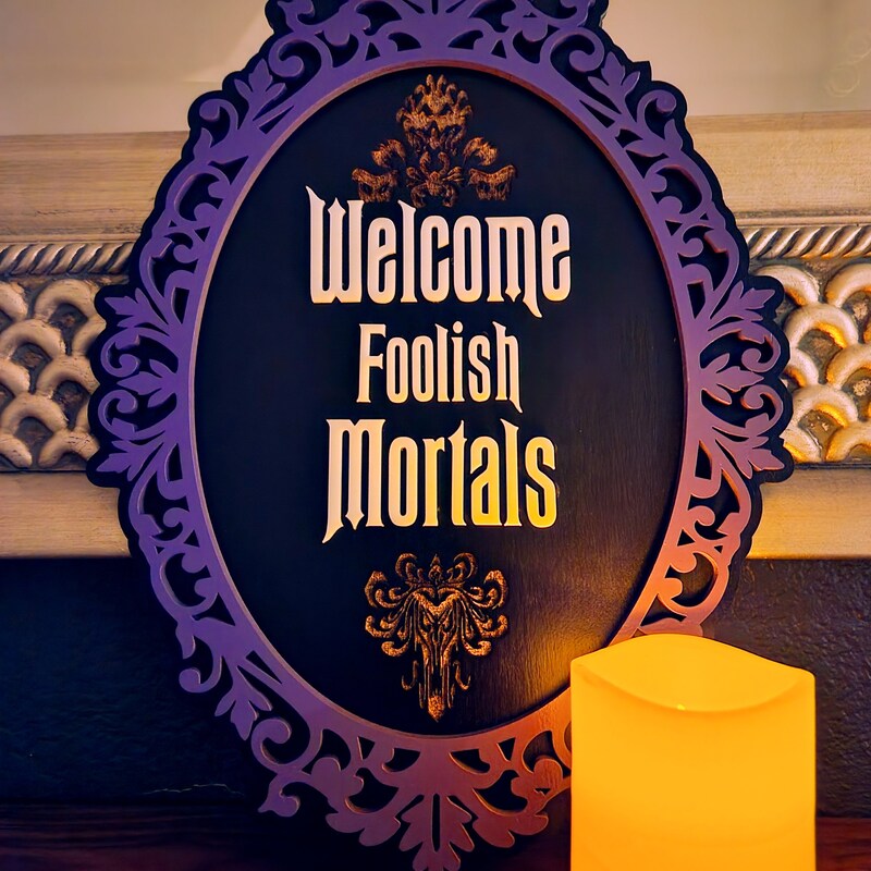 Smart Blonde 'Welcome Foolish Mortals' 12" Round Metal Sign | Halloween Spooky Home Decor