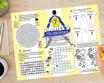 May include: A yellow and white printable activity sheet for a 7th birthday party featuring a soccer theme. The sheet includes a maze, word search, crossword puzzle, and a spot-the-difference game. The sheet features a cartoon image of a soccer player wearing a jersey with the number 7.