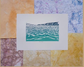 May include: A blue and green linocut print of a lake with a mountain range in the background. The print is titled "Pacific North".