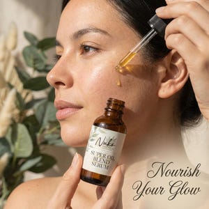 May include: A brown glass bottle of Nuko Skincare Co. Super Oil Blend Serum with a black dropper cap. The label features green leaf illustrations and the text Super Oil Blend Serum. A golden liquid drop is suspended from the glass pipette.