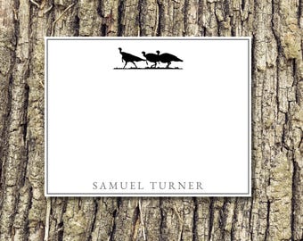 May include: A white card with a black silhouette of three turkeys walking. The card has a black border and the text "SAMUEL TURNER" at the bottom.