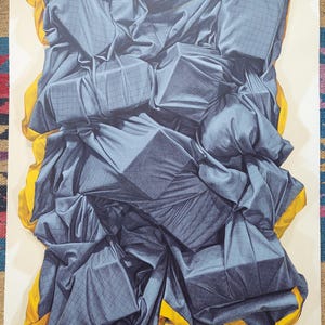 May include: An abstract artwork featuring a composition of draped, dark blue fabric with a grid pattern, accented by bright yellow trim. The fabric appears to be wrapped around geometric shapes, creating a textured, layered effect.