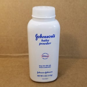 May include: A white Johnson's baby powder bottle with a white cap. The bottle has blue text that reads "Johnson's baby powder". The bottle also has text that reads "Keeps skin silky soft, fresh & comfortable". The bottle contains 4 oz (113g) of powder.