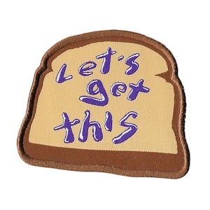 May include: A brown and tan embroidered patch shaped like a slice of bread with the text "Let's get this" in purple.