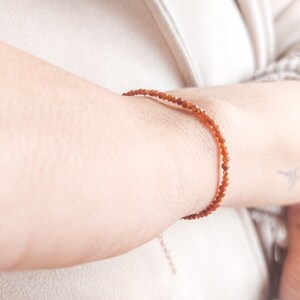 The aventurine bracelet is seen worn on a woman wrist, showing how well the tiny gemstones look on the skin.