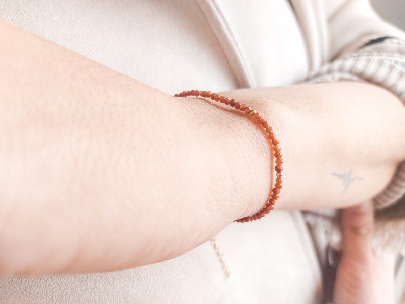 The aventurine bracelet is seen worn on a woman wrist, showing how well the tiny gemstones look on the skin.