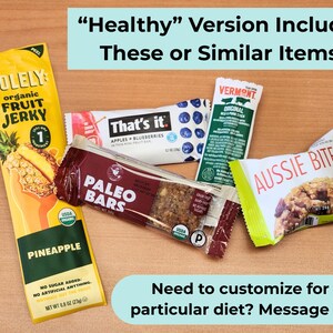 May include: An assortment of individually wrapped healthy snacks, including fruit jerky, paleo bars, and fruit and nut bars. The packaging features bright colors and product names like "Solely," "That's it," and "Aussie Bites."