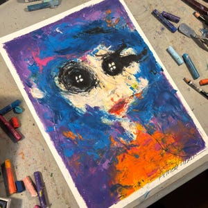 May include: Abstract expressionist painting on paper, featuring a face-like composition. The artwork uses bold brushstrokes and a vibrant palette of blues, purples, oranges, and black. The painting has a textured appearance, with visible layers of paint.