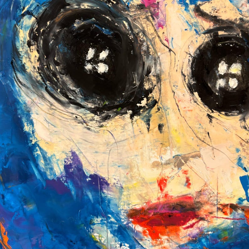 May include: Abstract painting featuring a face with large black eyes and red lips. The artwork uses a palette of blues, yellows, and whites, with visible brushstrokes and textured paint application. The eyes have white highlights.