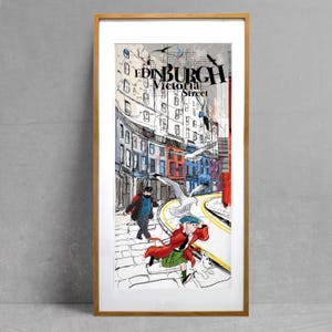 May include: A framed illustration of a street scene in Edinburgh, Scotland. The illustration features a couple walking down a cobblestone street with a seagull flying overhead. The text "EDINBURGH Victoria Street" is visible in the upper right corner of the image.