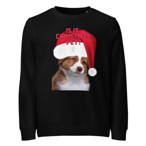 Cute, coy Australian Shepard pup with a wink and Santa hat wonders Is it Christmas yet? Animal lover, dog lover, Christmas sweatshirt, gift