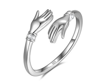 Umarmungsring aus 925 Sterling Silber I Umarmende Hände mit Zirkonia Steinen “Ausdruck von Zuneigung und Liebe” Ring für Damen und Frauen