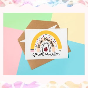 May include: A card with a rainbow design and the text "Live Love Teach Repeat" inside the rainbow. The rainbow is made to look like a pencil with an eraser. There is a red apple in the center of the rainbow. The text "special education" is below the rainbow.