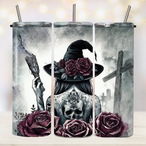 May include: A set of three stainless steel tumblers with a witch, roses, and a graveyard scene. The witch is wearing a black hat with roses on it and has a skull tattoo on her back. The tumblers are perfect for Halloween or any witchy occasion.