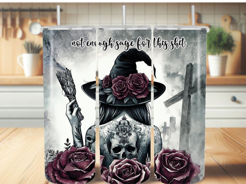 May include: A black and white illustration of a witch with a skull tattoo, holding a smudge stick. The witch is wearing a black hat with a wide brim and has roses in her hair. The background is a watercolor-style image of a graveyard with crosses and clouds. The text "not enough sage for this shit" is written in black at the top of the image.
