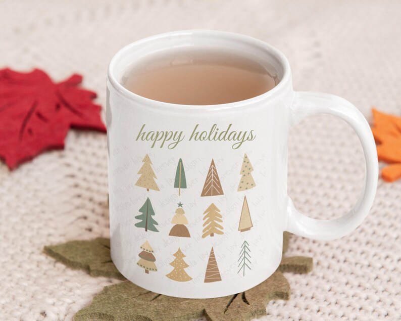 May include: White ceramic mug with a brown handle. The mug has a design of stylized Christmas trees in shades of green, brown, and beige. The text "happy holidays" is printed on the mug.