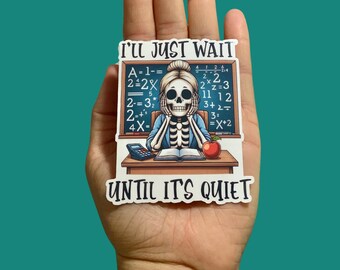 May include: A sticker with a skeleton teacher at a desk with a chalkboard behind them. The chalkboard has math equations on it. The sticker says "I'll just wait until it's quiet".