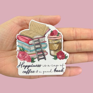 May include: A white sticker with a stack of books, a cup of coffee, and roses. The text reads "Happiness is a cup of coffee & a good book."