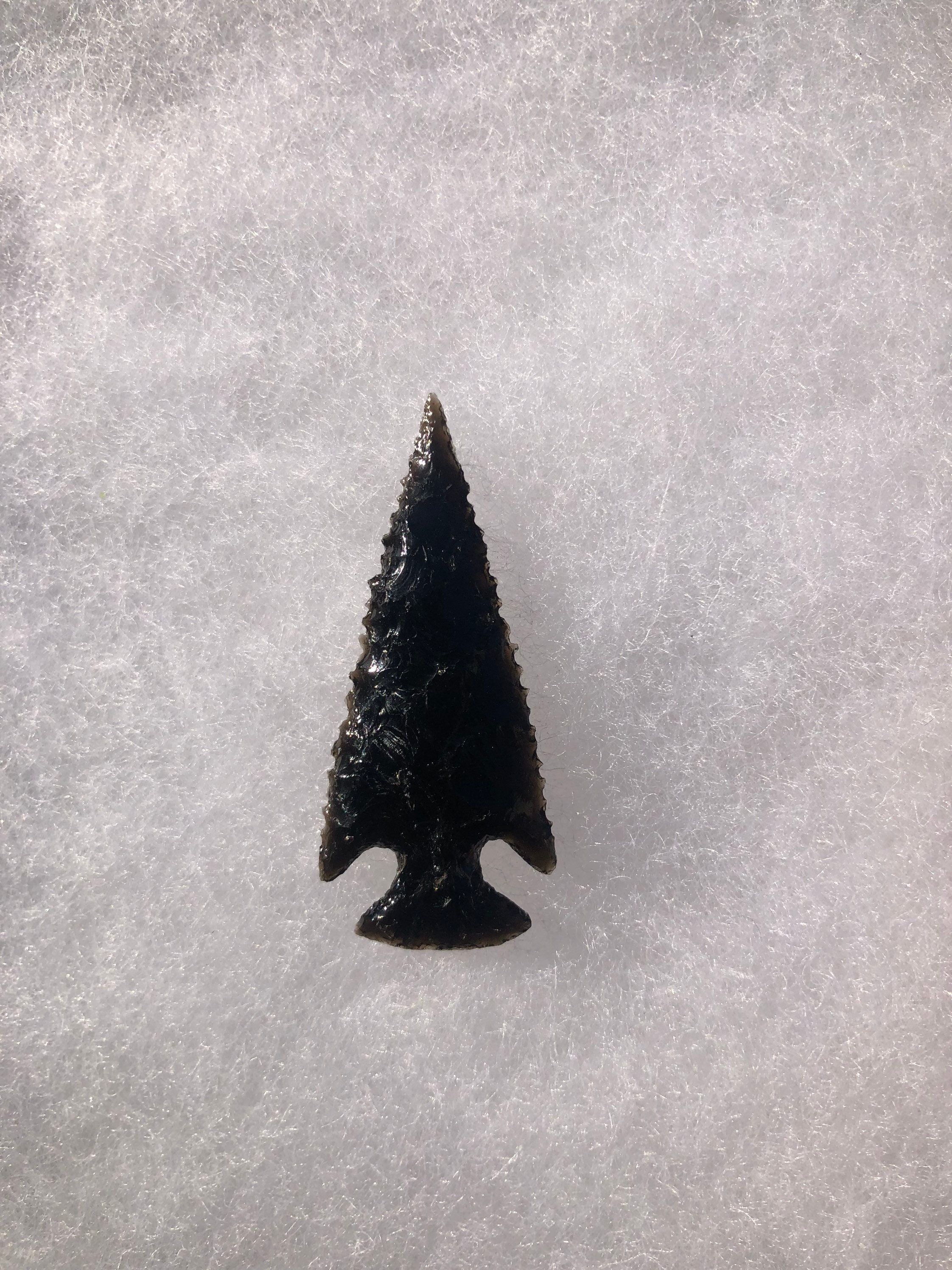 Translucent and striped obsidian corner notch arrowhead