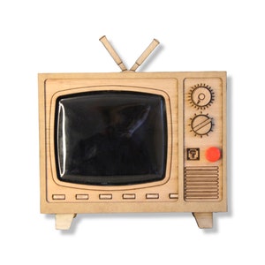 May include: Wooden retro television with a black screen, two antennas, and control knobs. The TV has a light brown finish with an orange button and is set against a white background. The design is reminiscent of vintage electronics.