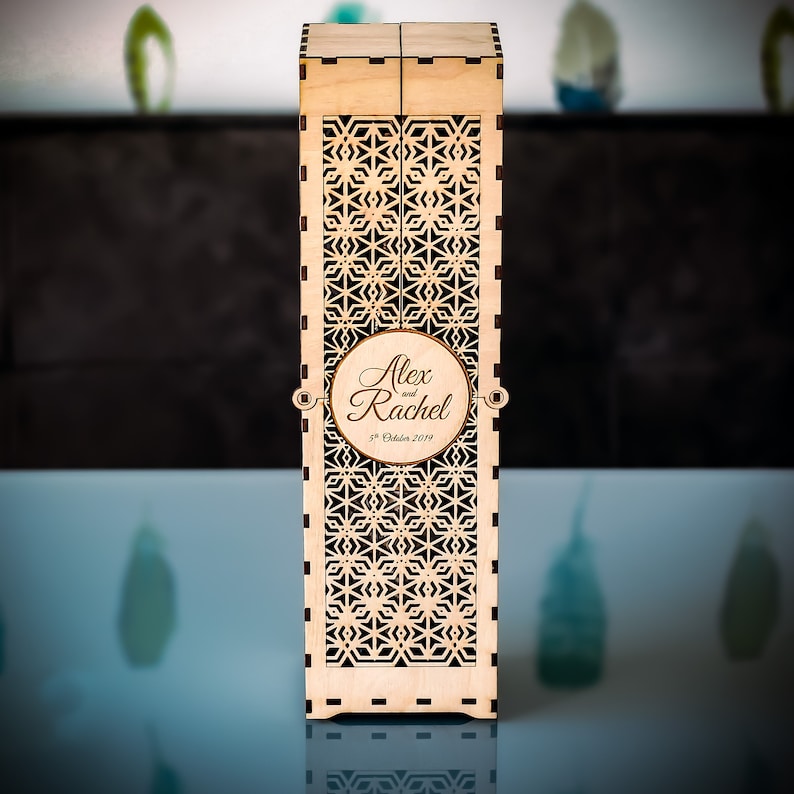 Personalised champagne keepsake gift box displayed closed. The box is made from laser cut wooden pieces with an original design. It has a stunning, geometric gradient cut out which decorates the front and back of the box.