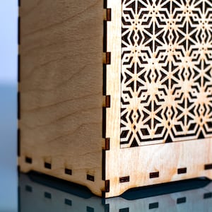 The base of the box ix fixed with a strong mortise and tenon joint. These laser cuts parts have been carefully designed to give a result which is both intricate and functional.