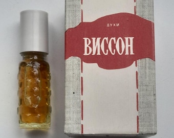 May include: A vintage perfume bottle with a silver cap and a textured glass body, next to its original box. The box features a red label with the Cyrillic word "ВИССОН" and the word "ДУХИ".
