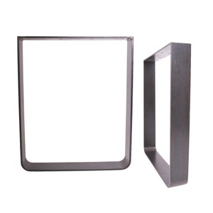 May include: Two metal table legs in a dark gray finish. The legs are rectangular in shape and have a simple, modern design.