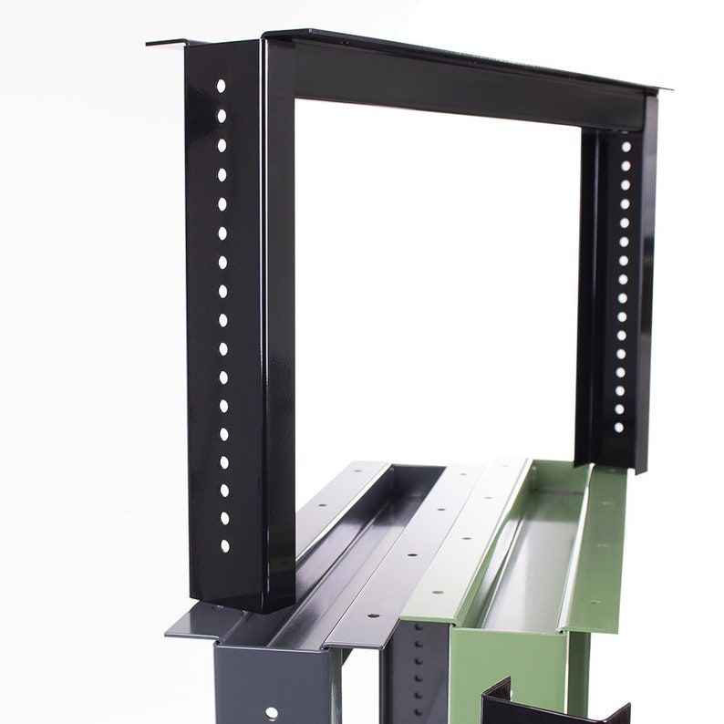 May include: Black metal rack with a green metal shelf. The rack has a series of holes along the sides for mounting equipment.