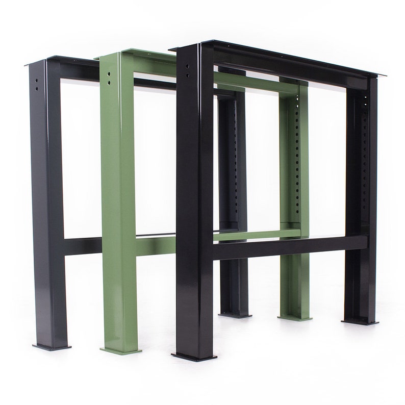 May include: Three metal table legs in black and green. The legs are made of sturdy metal and have a simple, industrial design.