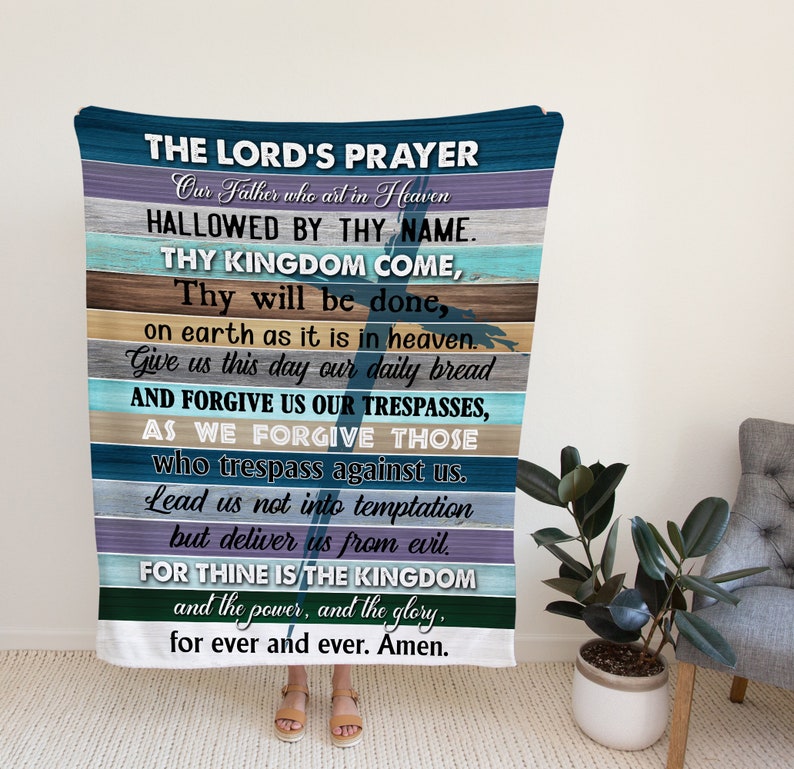 May include: A blue and white throw blanket with the Lord's Prayer printed on it. The text is in a white font and is centred on the blanket. The blanket is made of a soft, comfortable material and is perfect for snuggling up on the sofa.