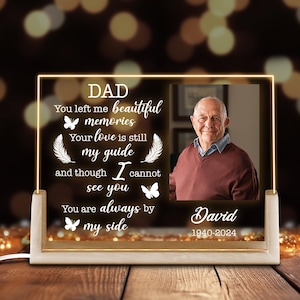 May include: A white LED light up memorial plaque with a photo of a man and a message that reads "DAD You left me beautiful memories Your love is still my guide and though I cannot see you You are always by my side David 1940-2024".