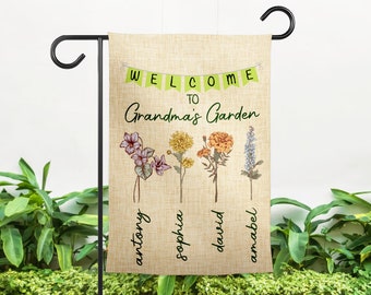 May include: Welcome to Grandma's Garden garden flag with a burlap background and green welcome banner. The flag features four different flowers with the names Anthony, Sophia, David, and Amabel written below each flower.