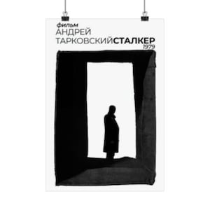 May include: Black and white poster for the film "Stalker" by Andrei Tarkovsky. The poster features a silhouette of a person standing in a doorway.