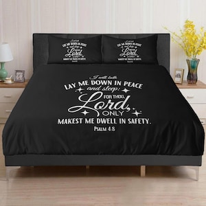 May include: Black bedding set featuring the text "I will both lay me down in peace and sleep: for thou, Lord, only makest me dwell in safety. Psalm 4:8." Includes two pillowcases with the same text in white.