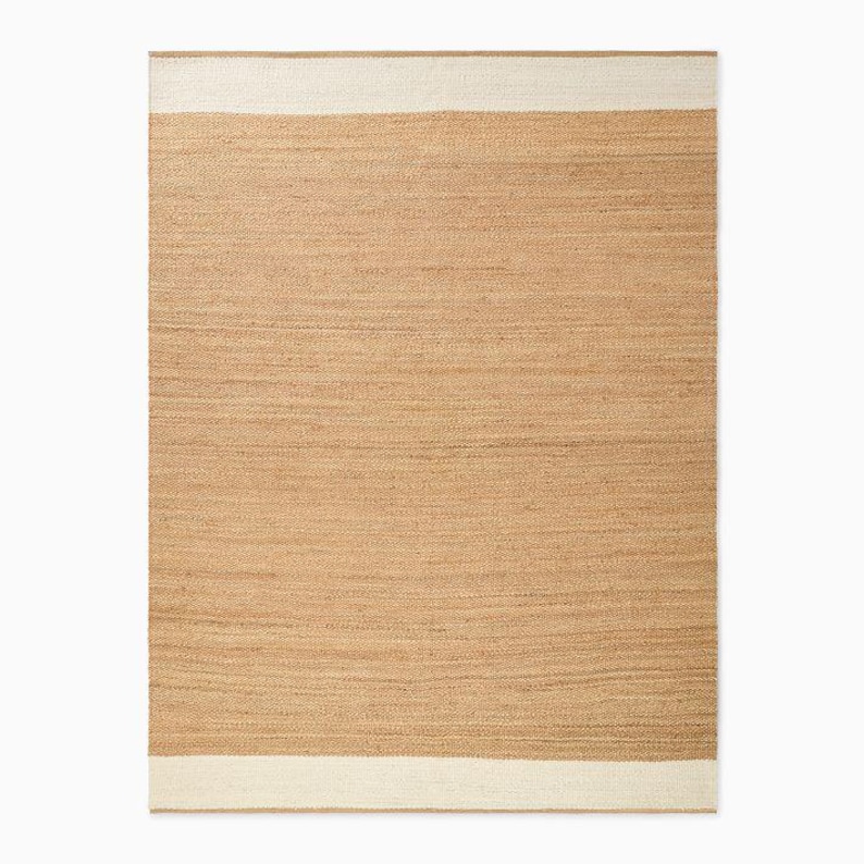 May include: A rectangular area rug featuring a large central section of woven tan natural fiber. The rug is bordered on the top and bottom edges by wide, solid off-white bands that run horizontally across the entire width of the piece.