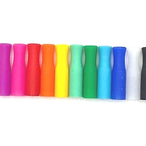 May include: A collection of colorful silicone mouthpieces in various colors, including purple, pink, red, orange, yellow, green, blue, and a black one. The mouthpieces are arranged in a row against a white background.