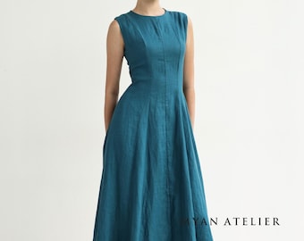 May include: A teal sleeveless dress with a fitted bodice and a flared skirt. The dress has a round neckline and falls to mid-calf. The text "YAN ATELIER" is visible at the bottom right. The dress is made of a soft, flowing fabric.