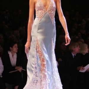 Full-length runway shot of a model showcasing the light blue silk slip dress, capturing the effortless movement, airy comfort, and couture-inspired elegance.
