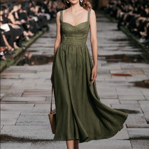 Olive green linen midi dress with hidden pockets and wide straps; minimalist wedding guest dress.