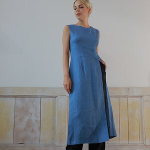 Full-body front view of the model standing confidently against a plain wall backdrop, capturing the complete elegant silhouette and creative contemporary lifestyle vibe of the ensemble.