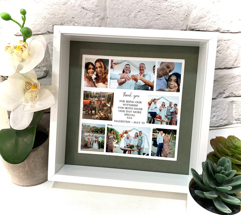 May include: A white frame with a green mat surrounding a collage of photos. The photos show a wedding party and the text "Thank you for being our witnesses! You both made our day more special. XXX Mauritius - May 23."