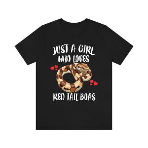 May include: Black t-shirt with the text "JUST A GIRL WHO LOVES RED TAIL BOAS". The shirt features a graphic of a coiled red tail boa snake with red heart accents.